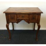 An Antique mahogany and walnut lowboy with three d