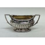 A matched pair of heavy cast silver sugar bowls of half fluted desi