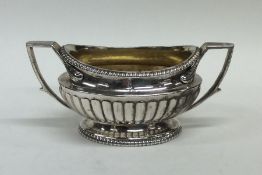 A matched pair of heavy cast silver sugar bowls of half fluted desi