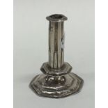 A miniature Queen Anne silver taper stick on stepp