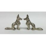 A pair of heavy Egyptian style silver dogs in seat
