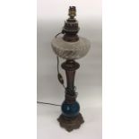 A Continental brass mounted oil lamp with glass re