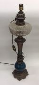 A Continental brass mounted oil lamp with glass re