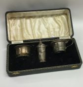 A cased silver three piece cruet set. Birmingham.