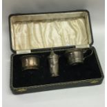 A cased silver three piece cruet set. Birmingham.