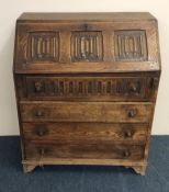 An oak Jacobean style bureau with full flap to bra