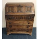 An oak Jacobean style bureau with full flap to bra