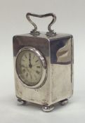 A miniature silver carriage clock with white ename