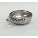 An Antique silver wine taster with snake handle an