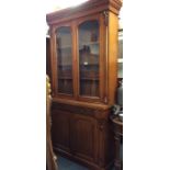 A mahogany glazed two door bookcase on pedestal ba