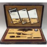 A cased travelling manicure set with fitted interi