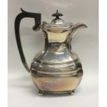 An Edwardian silver water jug with cut corners to