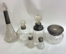 A collection of silver and cut glass mounted scent