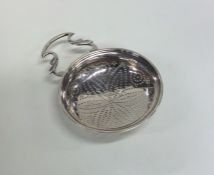 A Georgian silver lemon strainer with pierced body