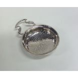 A Georgian silver lemon strainer with pierced body