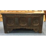 A large oak hinged top coffer with floral decorati