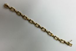 An 18 carat gold textured link bracelet with conce