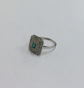 An Art Deco emerald and diamond cluster ring with