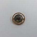 A circular gold brooch inset with Essex crystal de