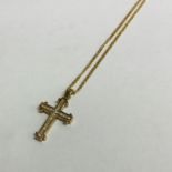 A boxed 9 carat cross inset with diamonds on fine