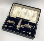 A cased silver three piece cruet set of baluster f