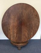 A mahogany tilt top table on circular base. Est. £