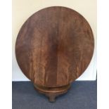 A mahogany tilt top table on circular base. Est. £