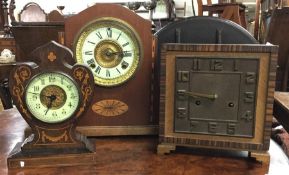 An inlaid mantle clock together with one other. Es