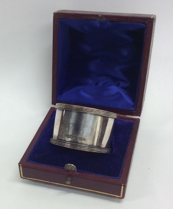 A plain heavy cased silver napkin ring with reeded