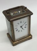 A small brass mounted carriage clock with white en