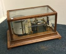 A good oak cased barograph on bracket feet. By Len