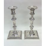 A good pair of George II cast silver candlesticks