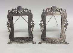 A pair of Chinese silver picture frames decorated