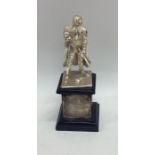 A cast silver model of a warrior on ebony base. Ap