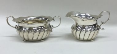 A pair of Continental silver cream and sugars of h