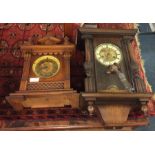 An oak mantle clock together with one other,