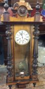 A walnut and mahogany wall clock.