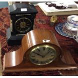 A slate mantle clock together with one other.