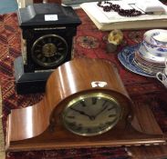 A slate mantle clock together with one other.