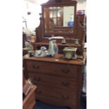 An Edwardian satinwood dressing chest.