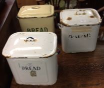 Three enamelled storage jars.