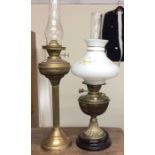 An old brass oil lamp together with one other.