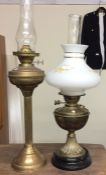 An old brass oil lamp together with one other.