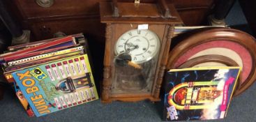A quantity of records pictures and a wall clock.