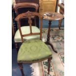 A mahogany tripod table together with two chairs.