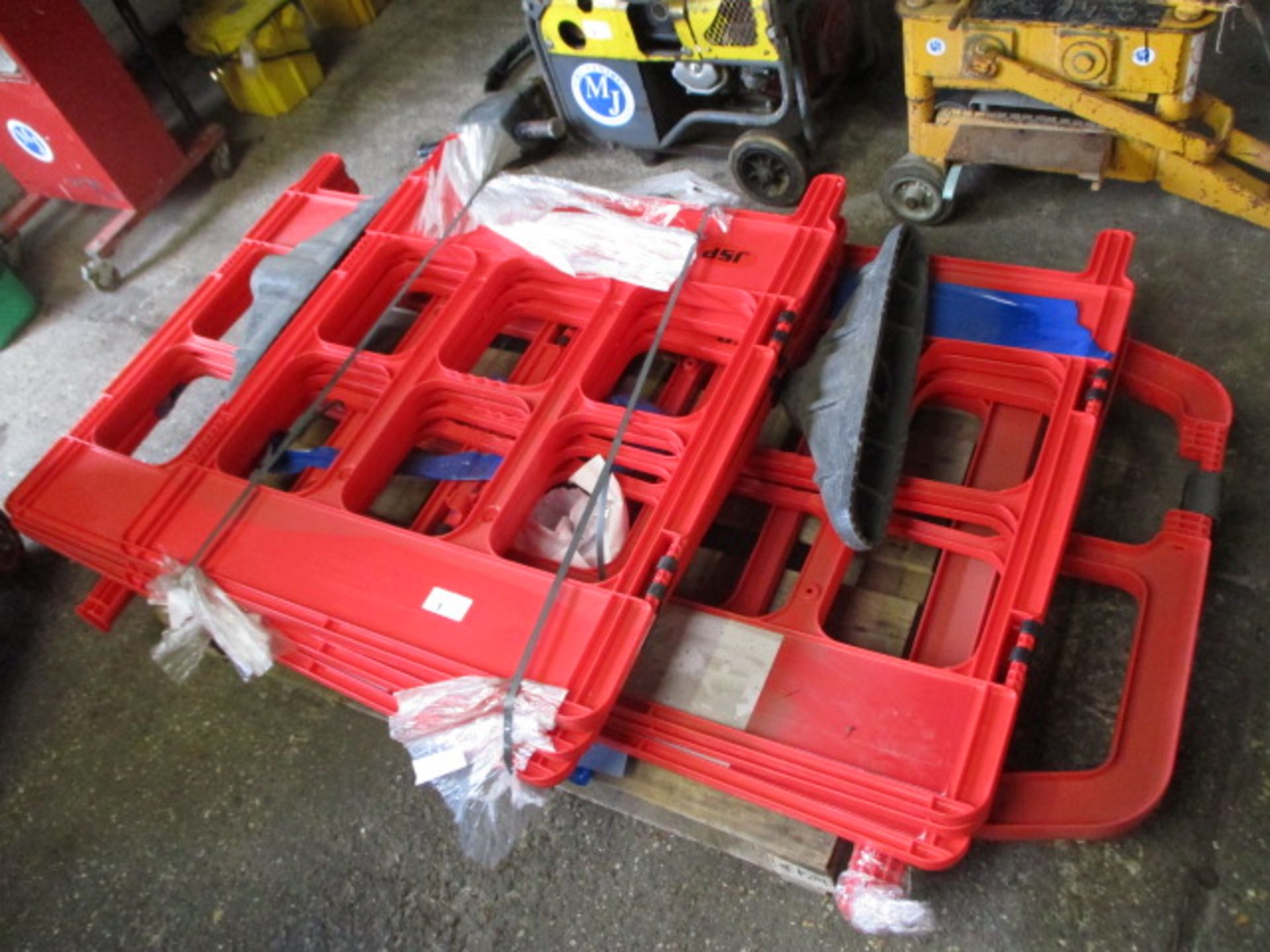 Pallet of red plastic pedestrian safety barriers