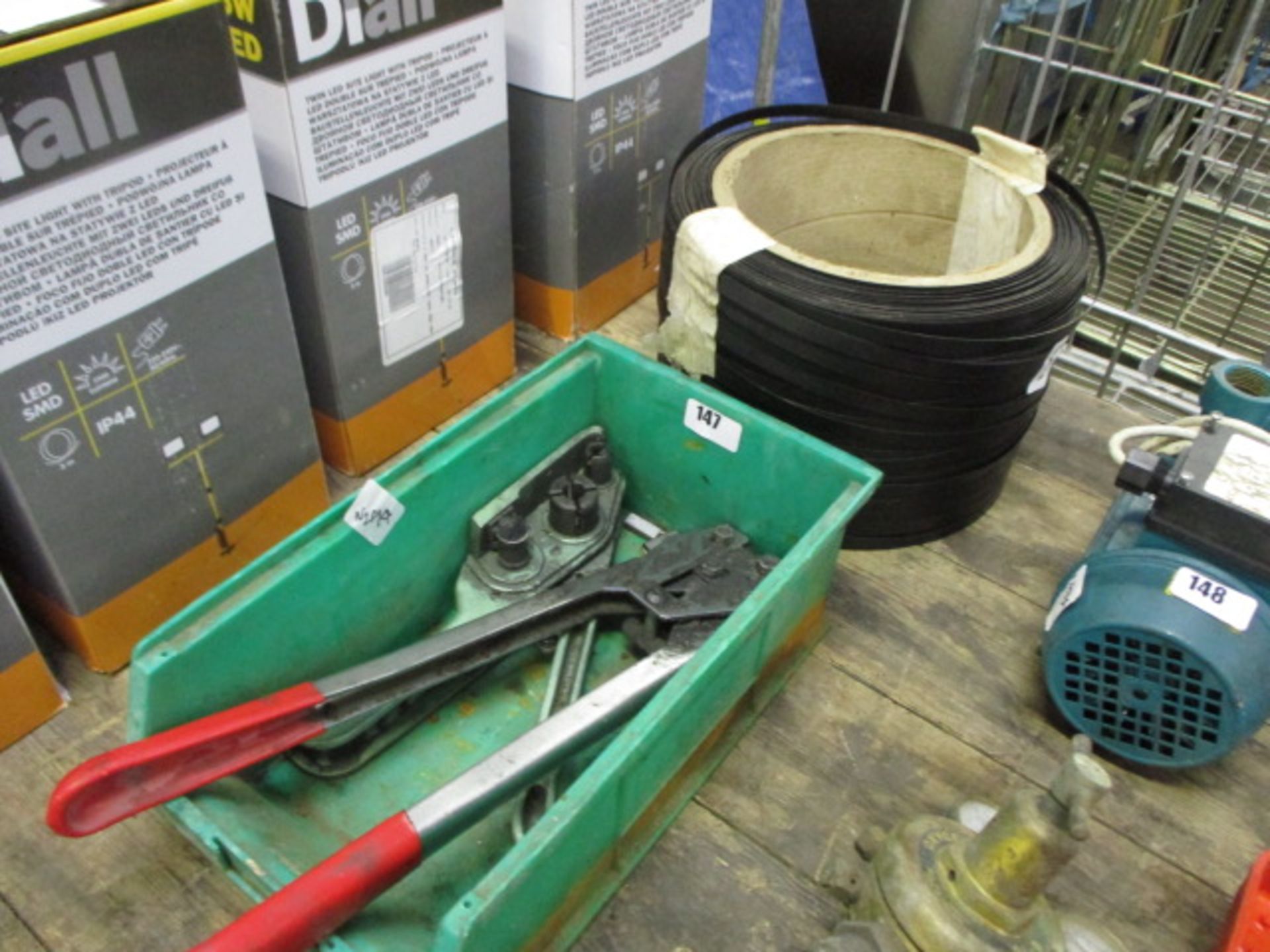 Large roll of strapping with band strapping tools and clips