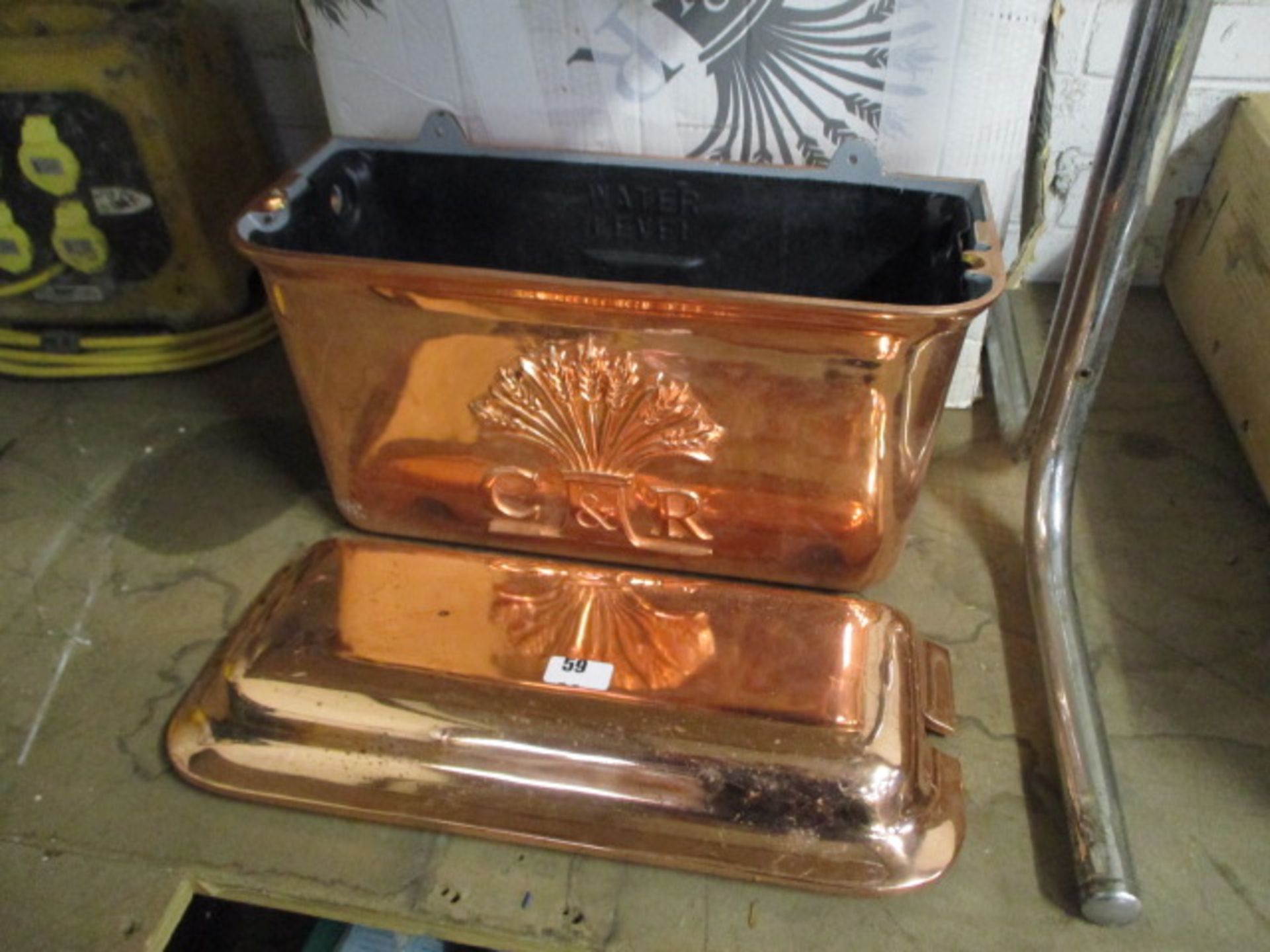 Copper coloured toilet cistern with lid