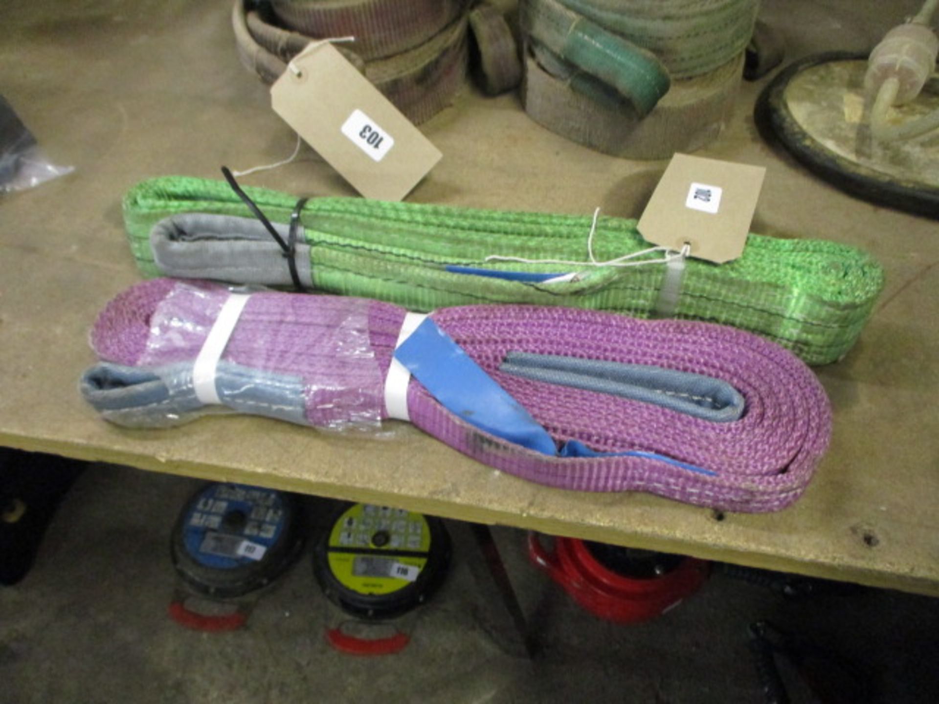 One green and one purple lifting strap