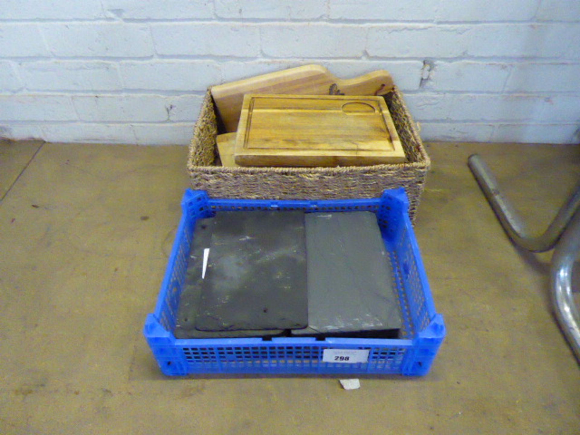 Plastic tray containing slate serving platters and wooden serving platters